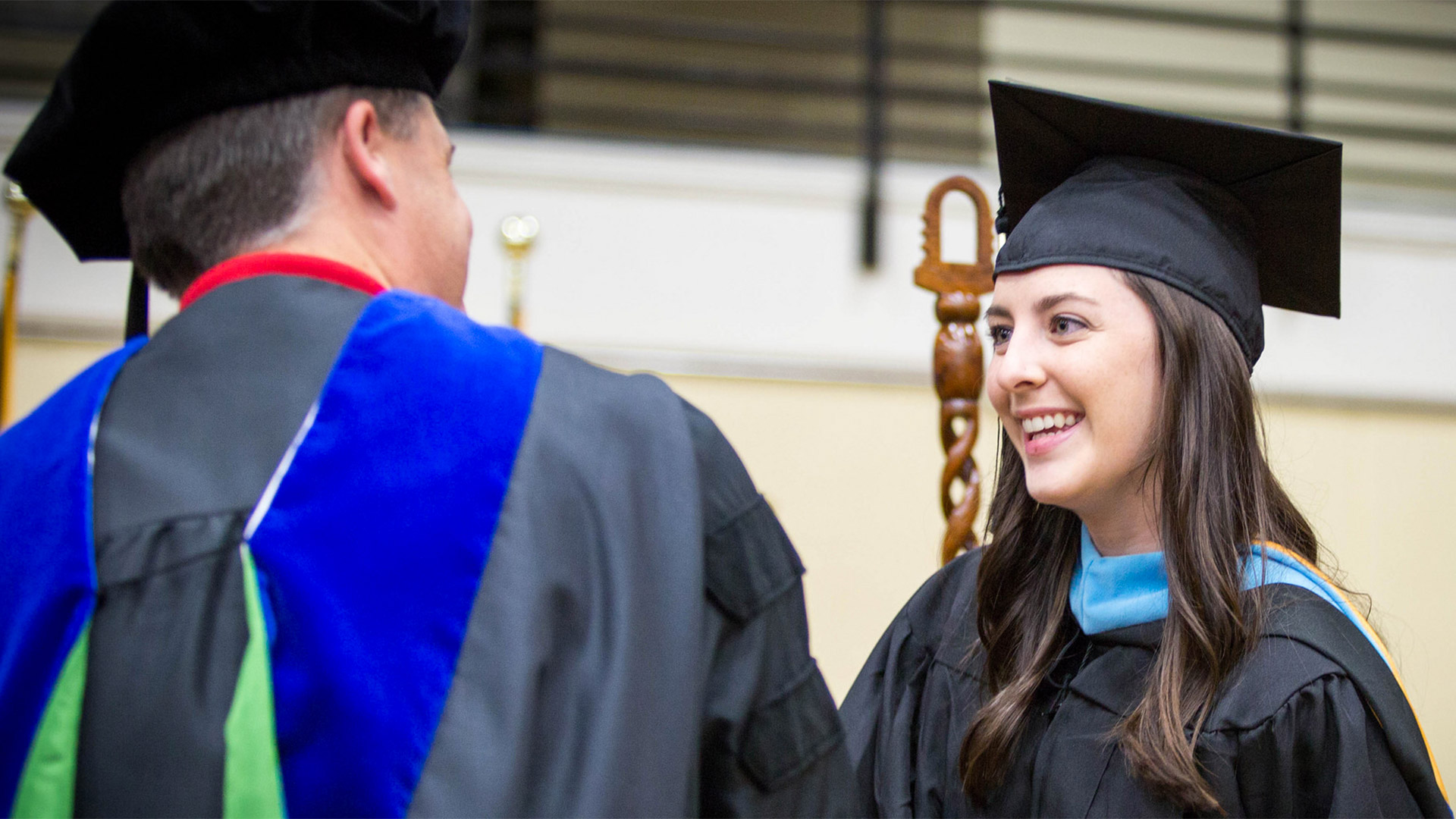 Graduating student with professor